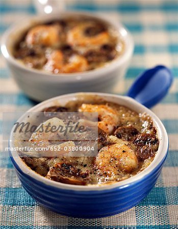 Small casserole dishes of seafood with mushrooms