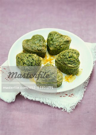 Heart-shaped spinach,orange zests and almond Flans