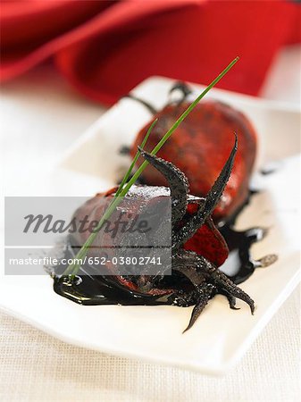 Red peppers stuffed with squid in squid ink sauce