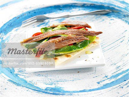 Fresh anchovy,sliced red pepper and cucumber crisp bread open-sandwich
