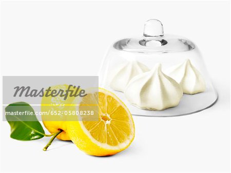 Small lemon-flavored meringues under a glass dome