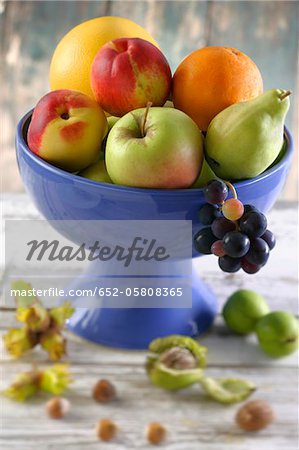 Bowl of summer fruit and fresh nuts