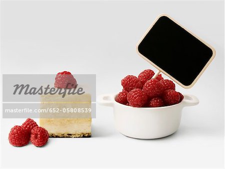 Small casserole dish of raspberries and sign for puree,cheesecake