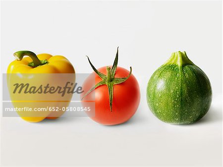 Yellow pepper,tomato and round zucchini in a row Yellow pepper,tomato and round zucchini in a row