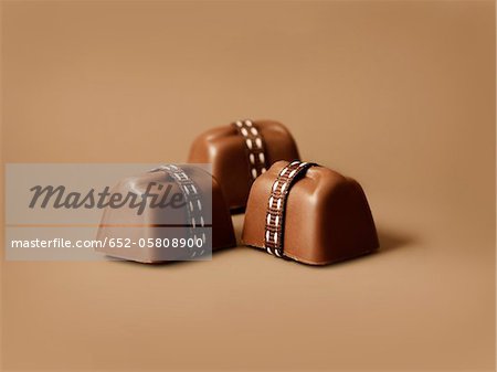 Three chocolates wrapped in ribbon