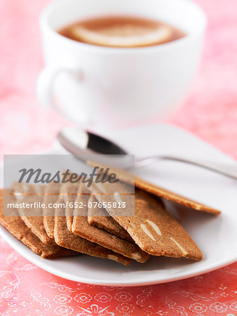 Cinnamon and thinly sliced almond cookies, a cup of coffee