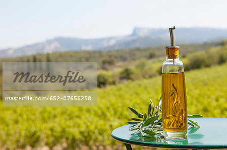 Bottle of olive oil on a table outdoors