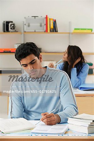 Young couple studying at desks