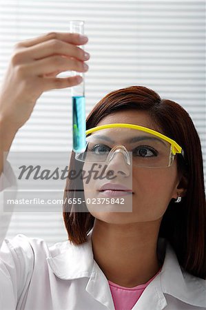Scientist with vile of liquid