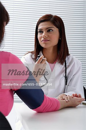 Doctor taking pulse of patient