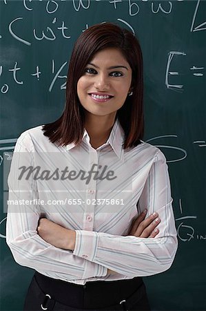 Teacher leaning against chalk board