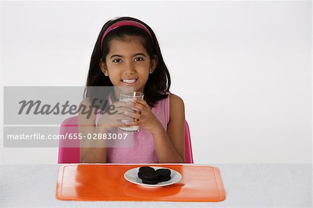 Girl with milk and cookies