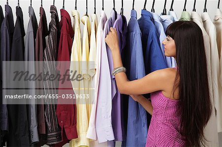 woman looking at rack of clothes
