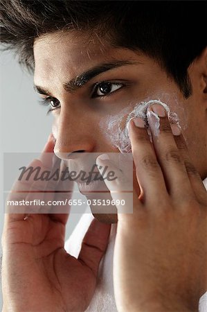 head shot of young man washing face