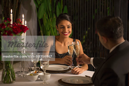 Singapore, Man and woman drinking champagne at romantic dinner