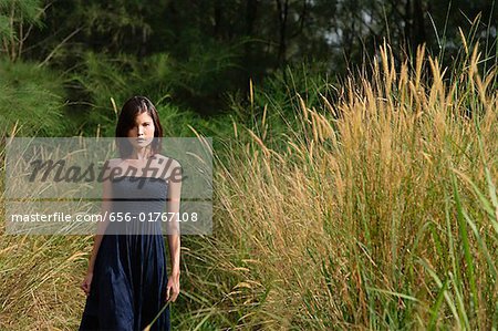 Woman walking in long grass