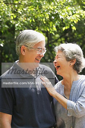 Senior couple facing each other, smiling