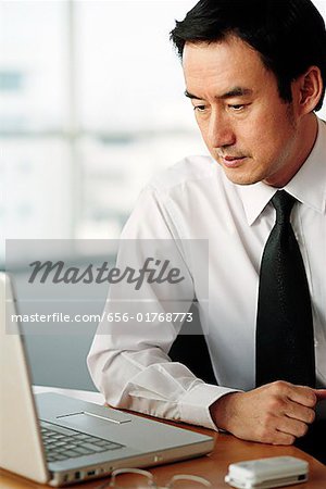 Businessman looking at laptop