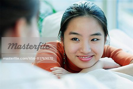 Young woman smiling at person in front of her