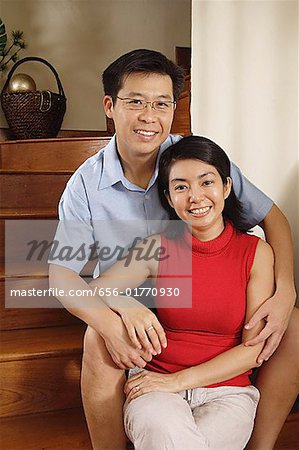 Couple at home, sitting on stairs