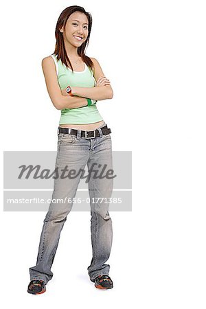 Young woman in tank top and jeans arms crossed, smiling at camera - Stock  Photo - Masterfile - Premium Royalty-Free, Code: 656-01771385