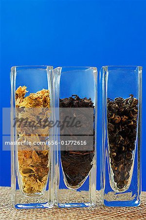Row of three glass containers with tea leaves
