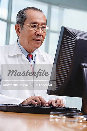 Doctor using desktop computer