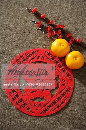 Still life of pair of mandarin oranges with Chinese character for "fortune"