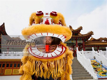 little boy inside of Chinese lion dance costume