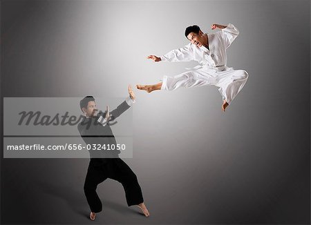 two men sparring with Filipino stick fighting martial arts Stock Photo