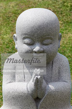 Close up of Buddhist statue praying