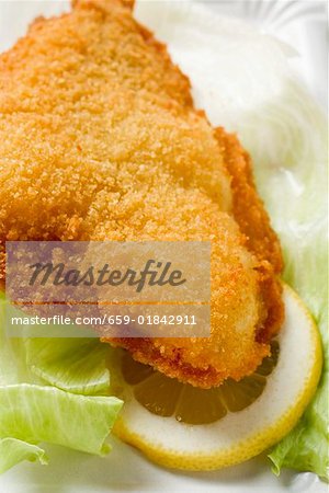 Fish nugget with lettuce leaf and slice of lemon