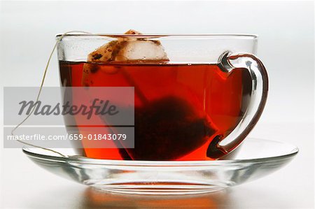 Hibiscus tea in glass cup with tea bag