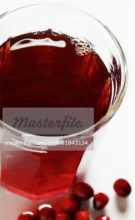 Cranberry juice in glass, fresh cranberries