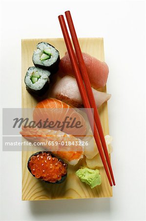 Mixed sushi platter with red chopsticks