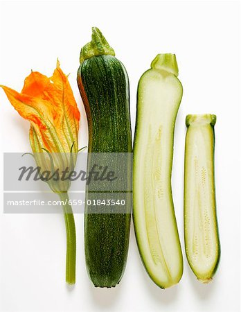 Whole and half courgette with courgette flower