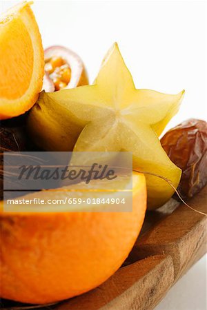 Exotic fruit still life with coconut in wooden bowl