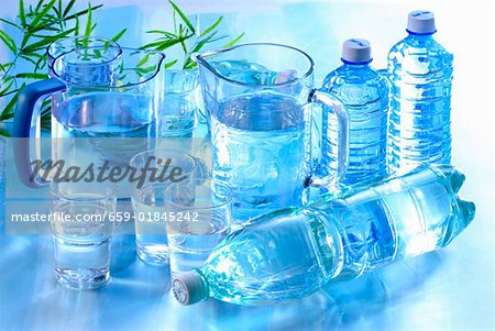 Water in glasses, jugs and plastic bottles