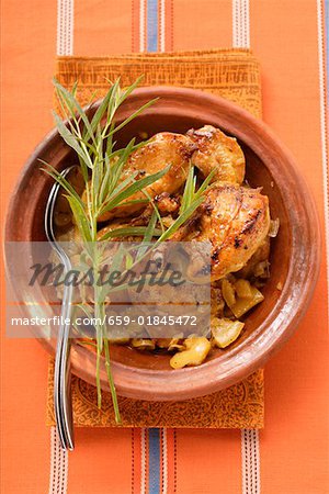 Braised chicken with onions and tarragon in tajine