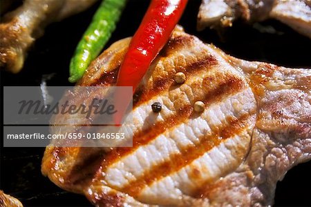 Grilled pork chop with pepper and chili peppers