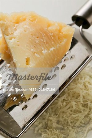 Piece of Pecorino with grater (close-up)