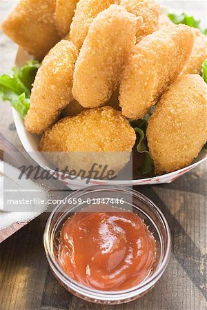 Chicken Nuggets in cardboard dish ketchup, salt