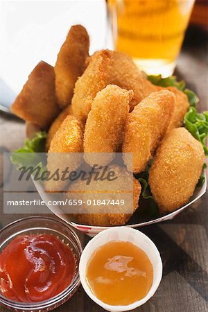 Chicken Nuggets in cardboard dish ketchup & sweet & sour sauce