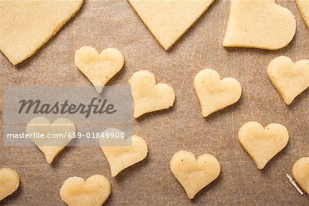 Cut-out biscuits on baking parchment