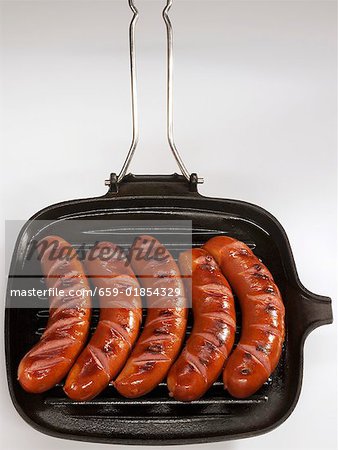 Five bockwurst sausages in a grill pan Five bockwurst sausages in a grill pan