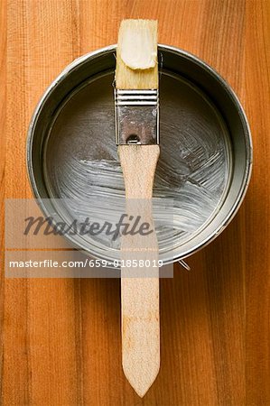 Pastry brush with butter on baking tin