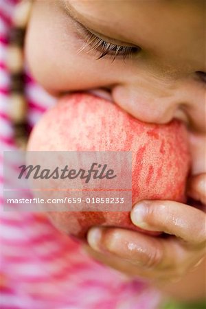 Child biting into juicy nectarine