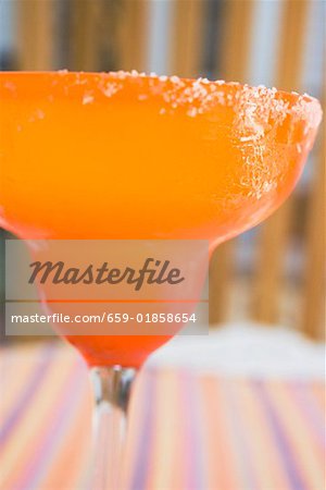 Margarita in orange glass with salted rim Margarita in orange glass with salted rim