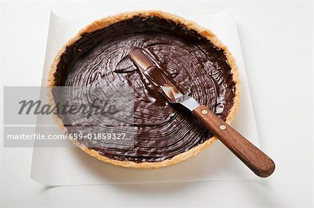 Spreading pastry case with chocolate