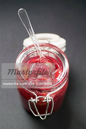 Gooseberry jam in jar with spoon